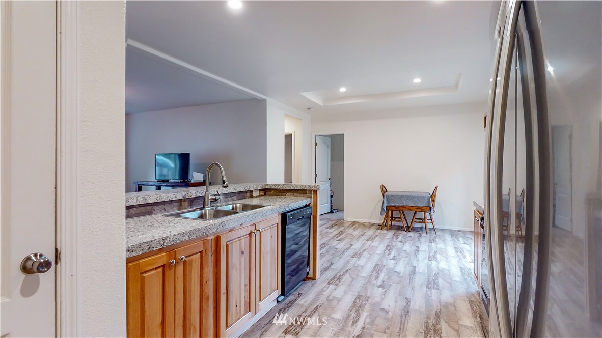 729 Cinebar Road, Unit A Cinebar, WA 98533 - Photo 10 of 30 a kitchen with stainless steel appliances granite countertop a stove and a wooden floors