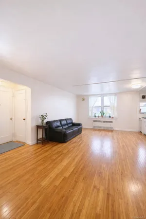 a view of kitchen and hall with wooden floor