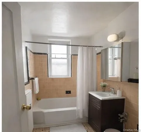 a bathroom with a sink a mirror and a bathtub