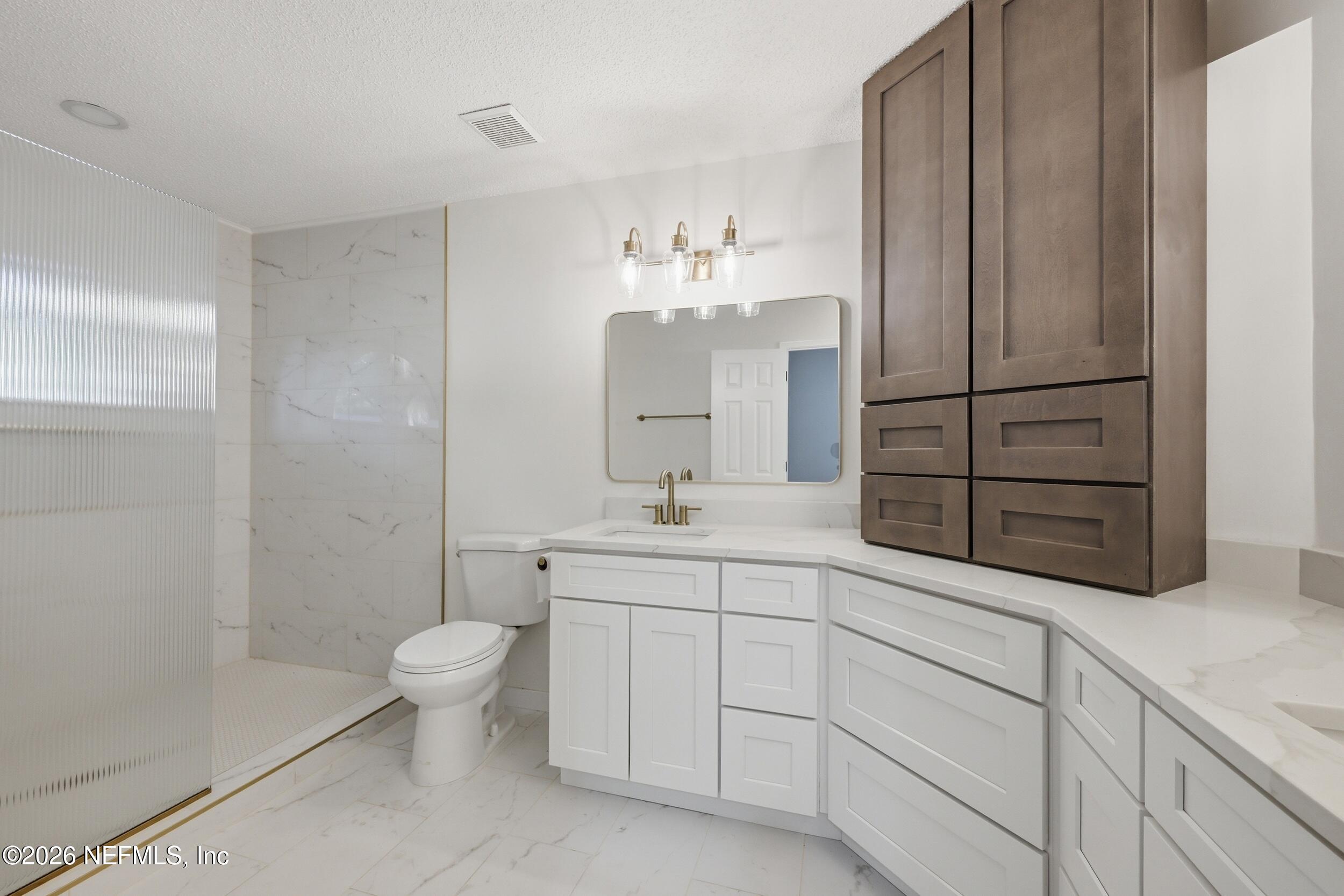 3286 Marbon Road Jacksonville, FL 32223 - Photo 24 of 36 a spacious bathroom with a double vanity sink a mirror and a shower