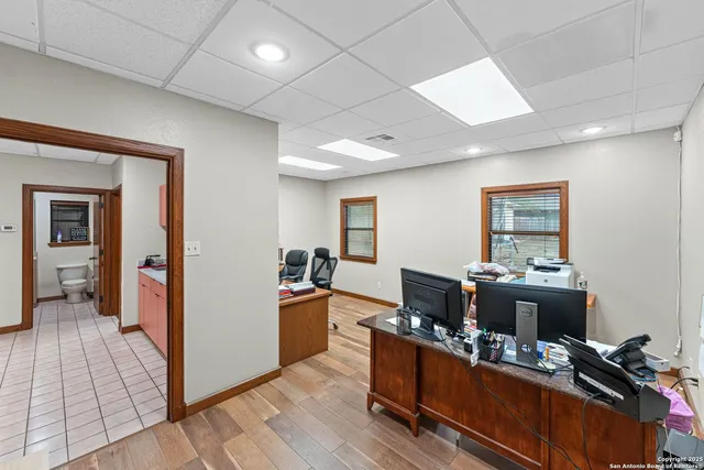 a large kitchen with kitchen island granite countertop a large counter top space and wooden floor