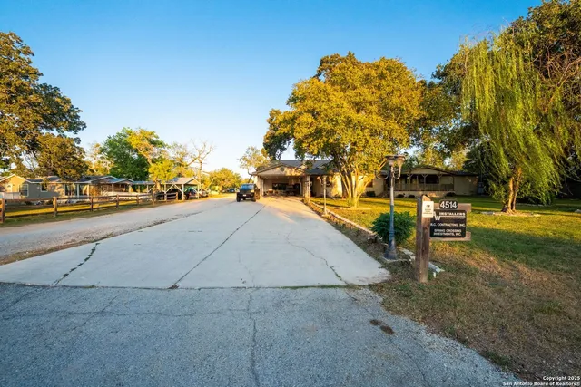 a view of a swimming pool with a patio and a yard