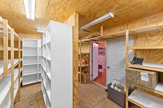 a view of a white house with a big yard and large trees