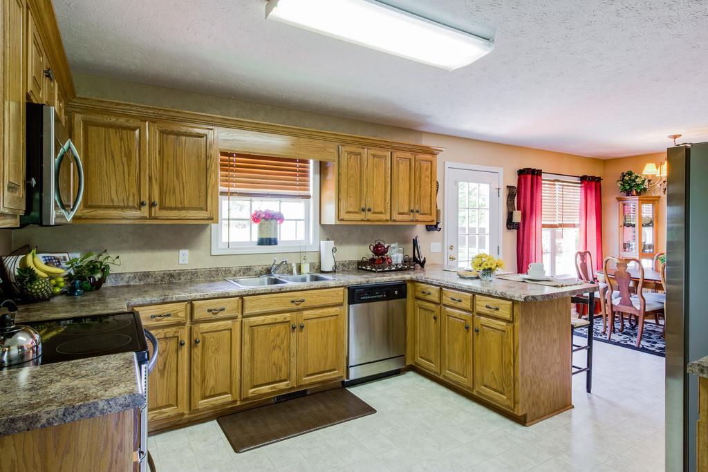 5004 Maple Springs Road Manchester, TN 37355 - Photo 18 of 22 a kitchen with a sink a stove and cabinets