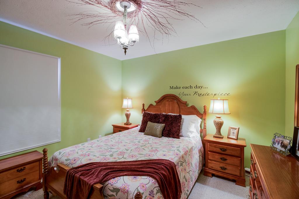 5004 Maple Springs Road Manchester, TN 37355 - Photo 20 of 22 a bedroom with a bed and a chandelier
