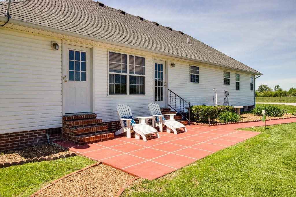 5004 Maple Springs Road Manchester, TN 37355 - Photo 3 of 22 a backyard of a house with yard and outdoor seating