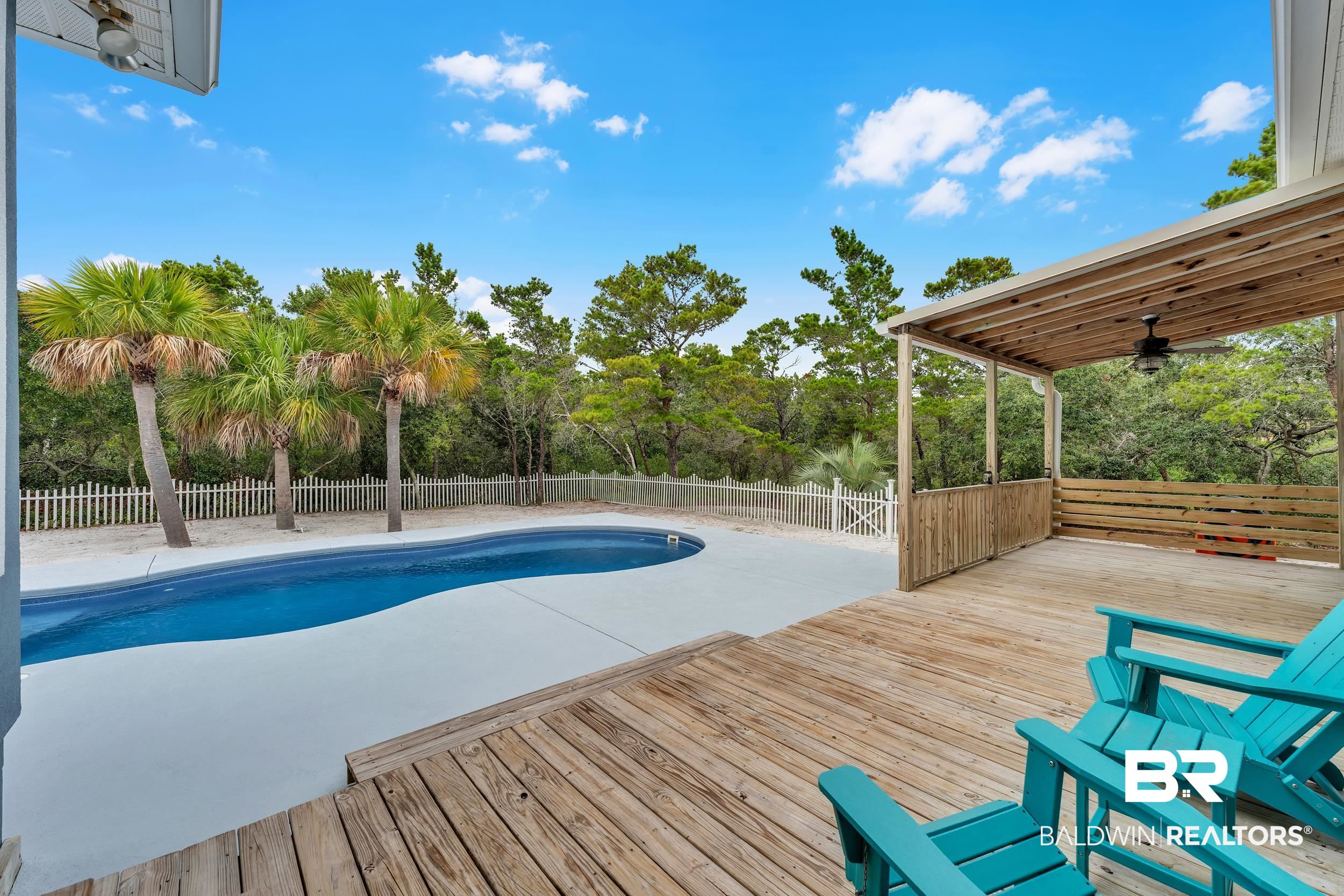 4606 Osprey Drive Orange Beach, AL 36561 - Photo 11 of 44 View of swimming pool with a fenced backyard, a wooden deck, and view of lot next door