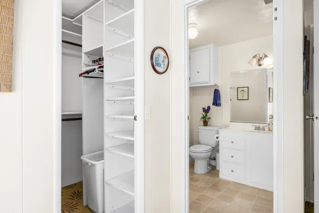 a view of bathroom with a toilet a sink and a mirror
