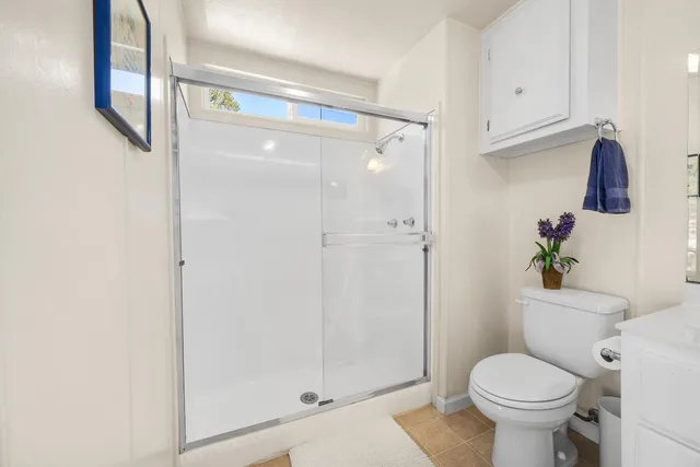 a bathroom with a toilet and a shower