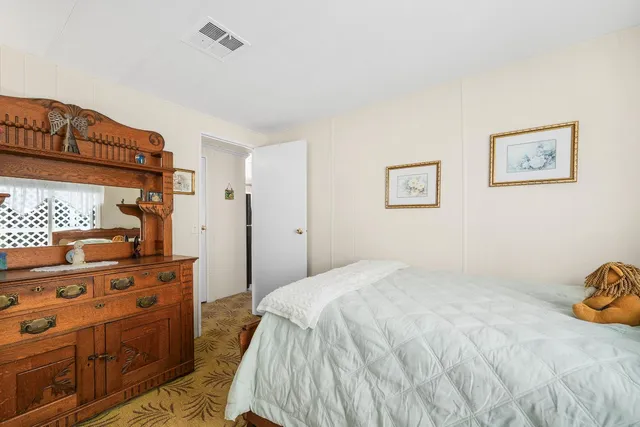 a bedroom with a bed and a dresser