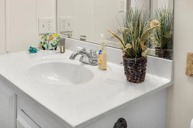 a bathroom with a sink a vanity and a mirror