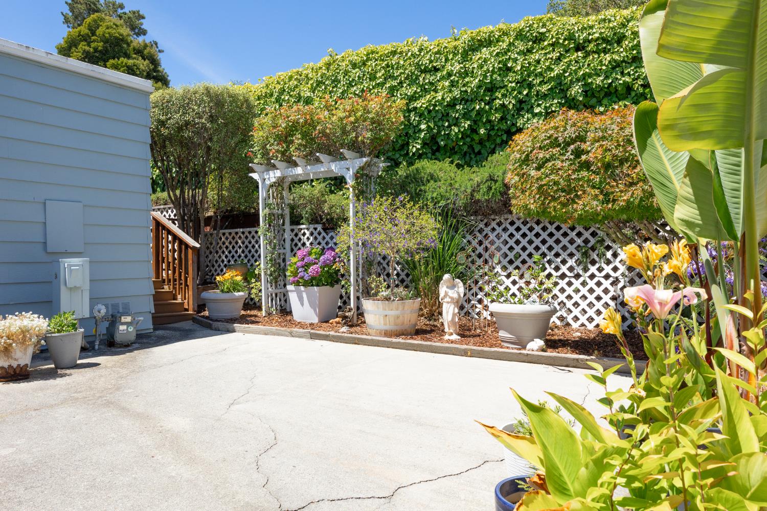 2435 Felt Street, Unit 24 Santa Cruz, CA 95062 - Photo 29 of 38 a view of a wooden door with a bench in patio