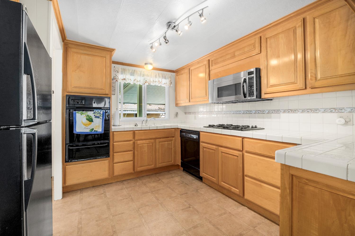 2435 Felt Street, Unit 24 Santa Cruz, CA 95062 - Photo 10 of 38 a kitchen with stainless steel appliances granite countertop a refrigerator and cabinets