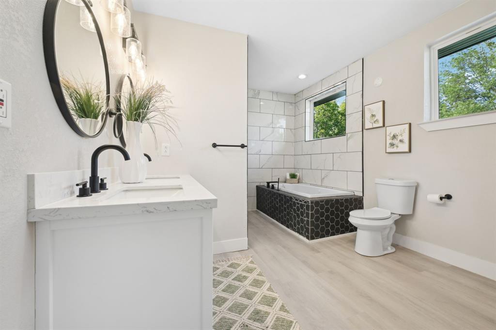 702 Griffith Avenue Terrell, TX 75160 - Photo 25 of 40 a bathroom with a toilet a sink and a mirror