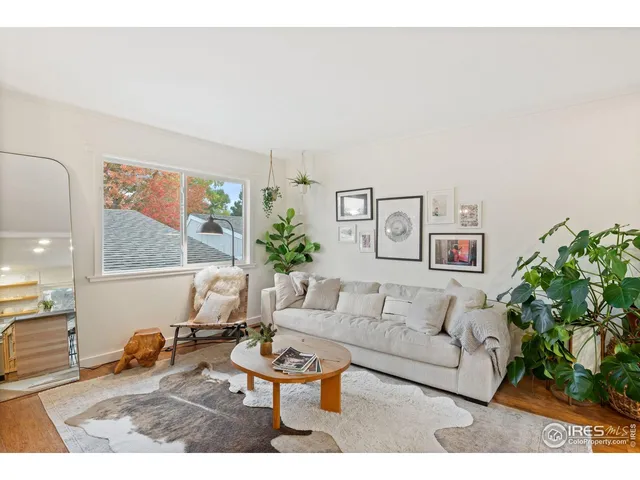 a living room with furniture and a painting