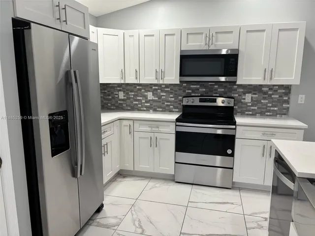 a kitchen with a stove microwave and refrigerator