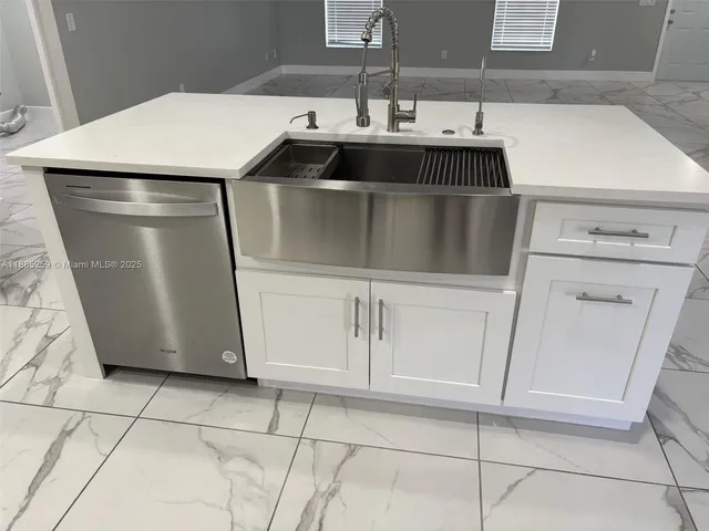 a kitchen with a sink and a washer dryer