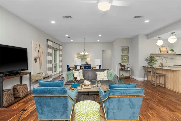 a living room with fireplace furniture and a flat screen tv