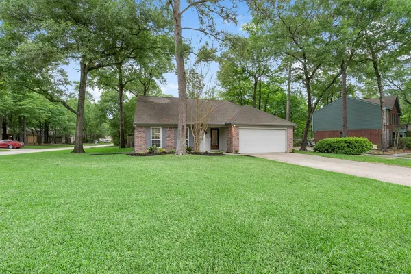 a view of a house with a yard and tree