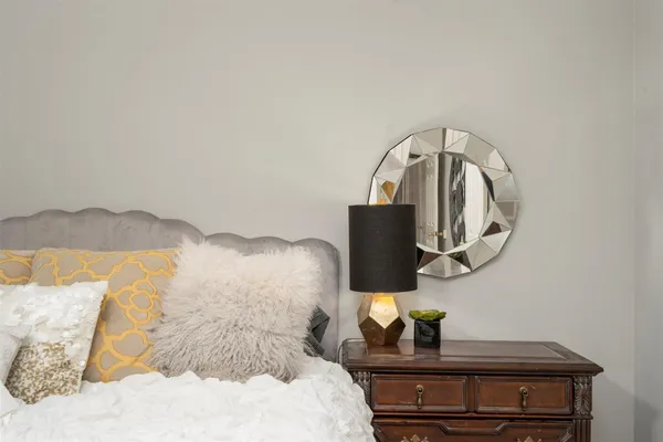 a bedroom with a bed and a mirror
