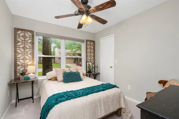 a bedroom with a bed and a window