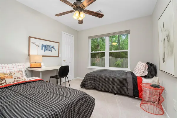 a bedroom with a bed and large window