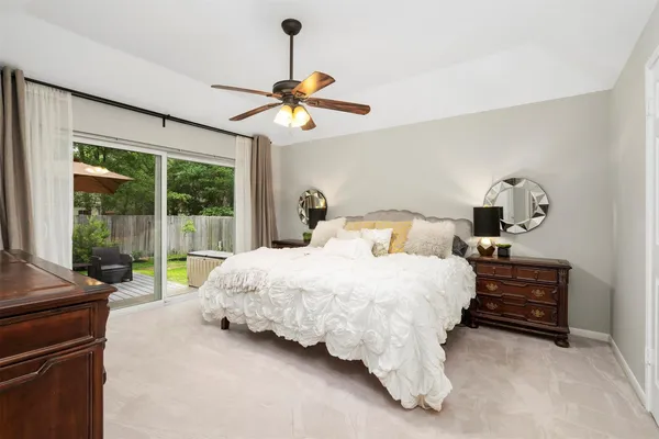 a bedroom with bed and a chandelier