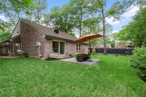 a view of a wooden bench in front of house