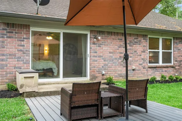 a view of a backyard with a sitting area and a garden