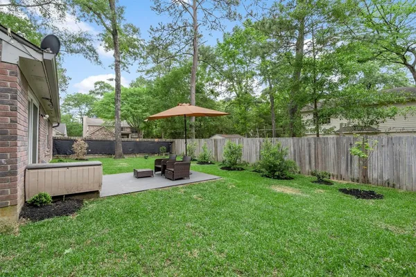 a front view of a house with a yard and green space