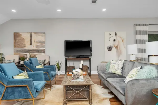 a living room with furniture and a flat screen tv