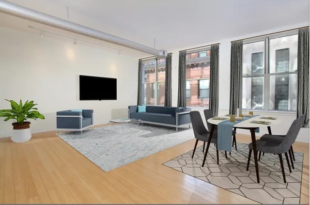 a view of a livingroom with furniture and a flat screen tv