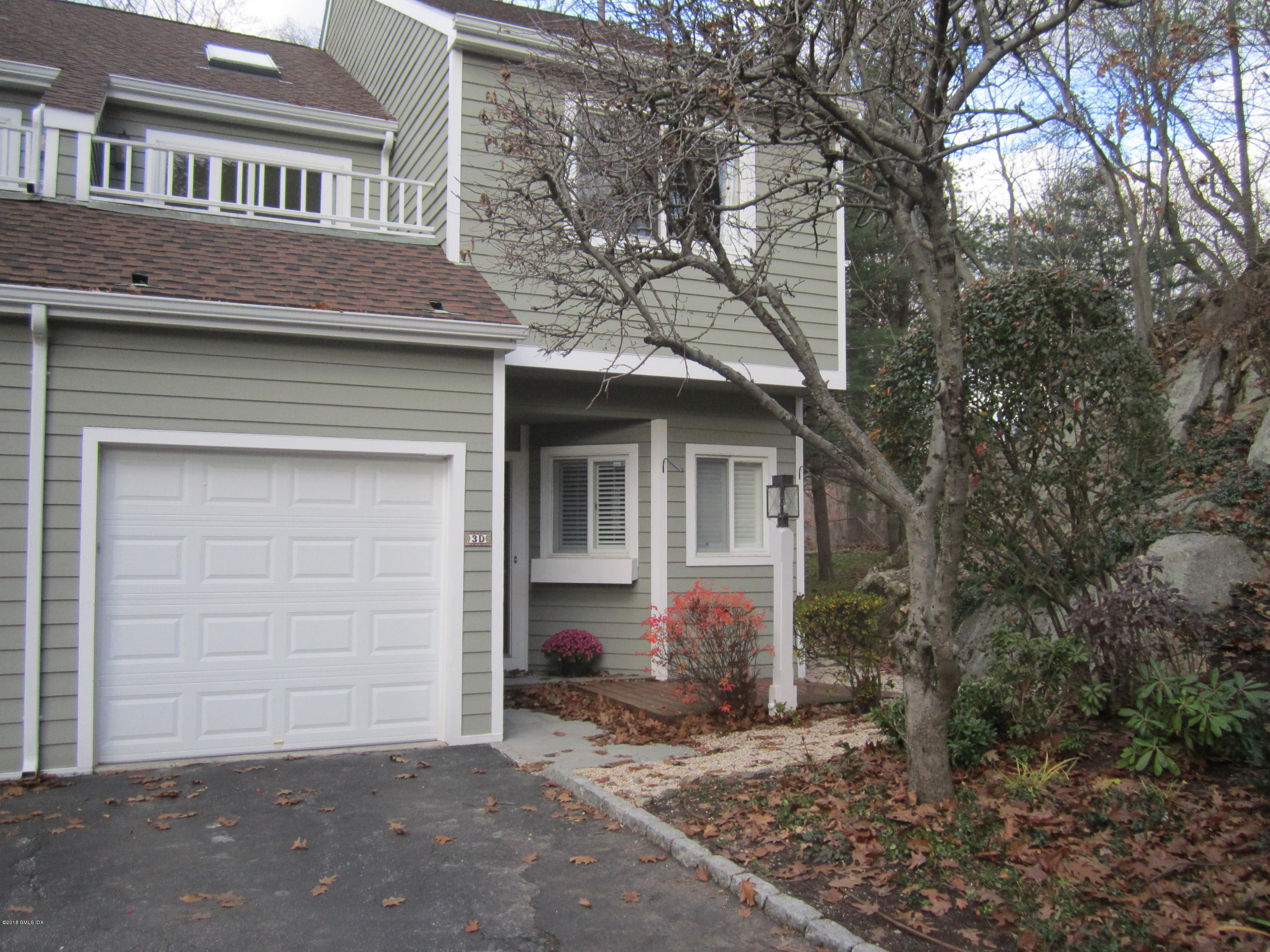 333 Palmer Hill Road, Unit 3D Riverside, CT 06878 - Photo 1 of 15 a front view of a house with a yard and garage