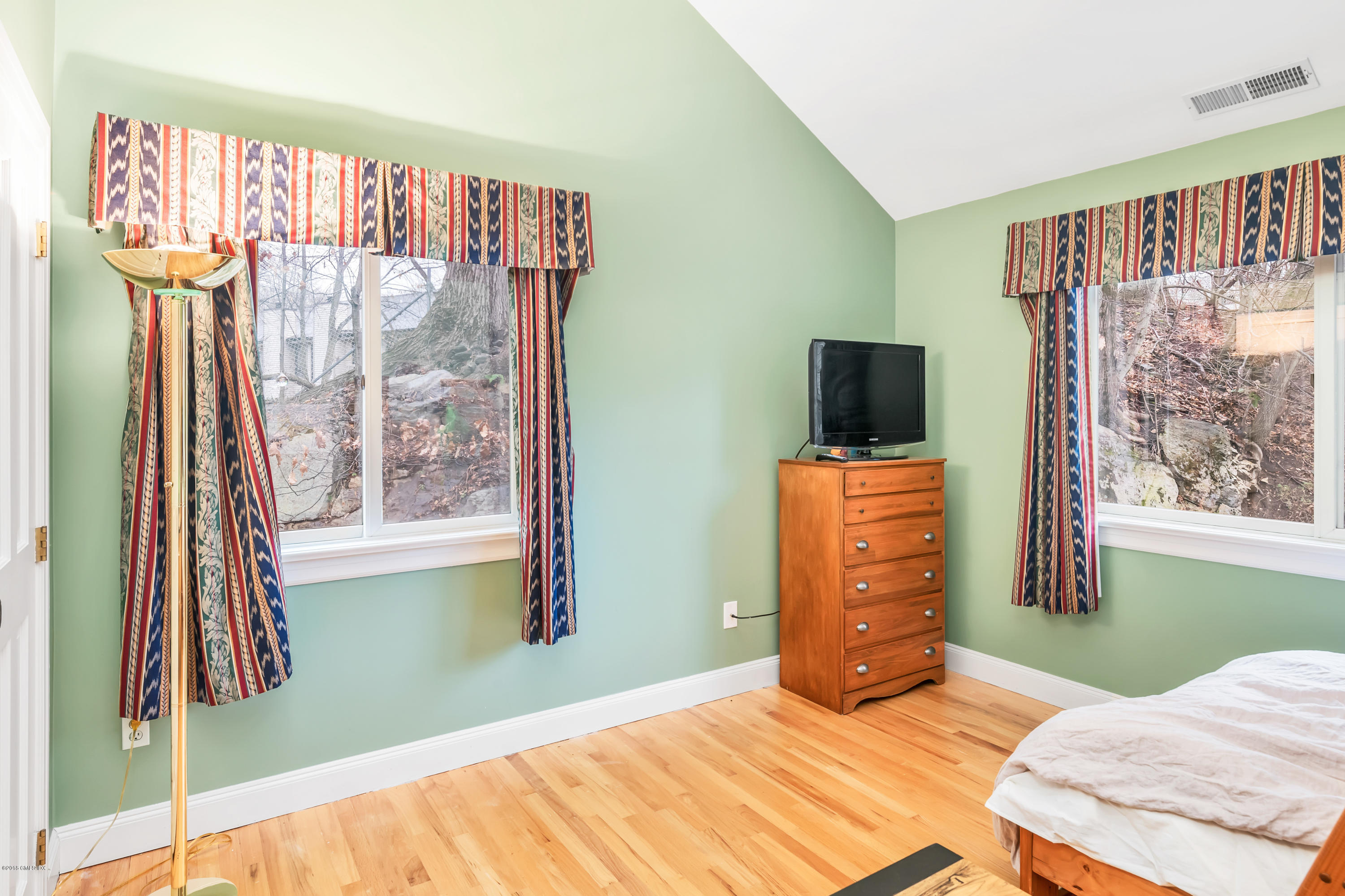 333 Palmer Hill Road, Unit 3D Riverside, CT 06878 - Photo 12 of 15 a bedroom with a bed and a flat tv screen