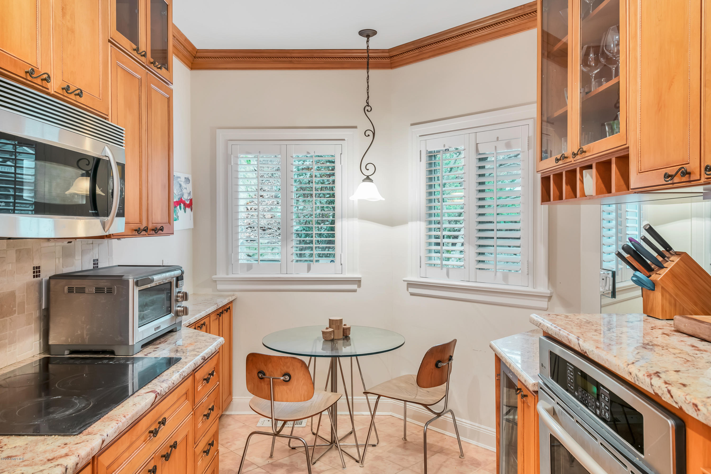 333 Palmer Hill Road, Unit 3D Riverside, CT 06878 - Photo 6 of 15 a kitchen with stainless steel appliances granite countertop a stove a sink and a microwave