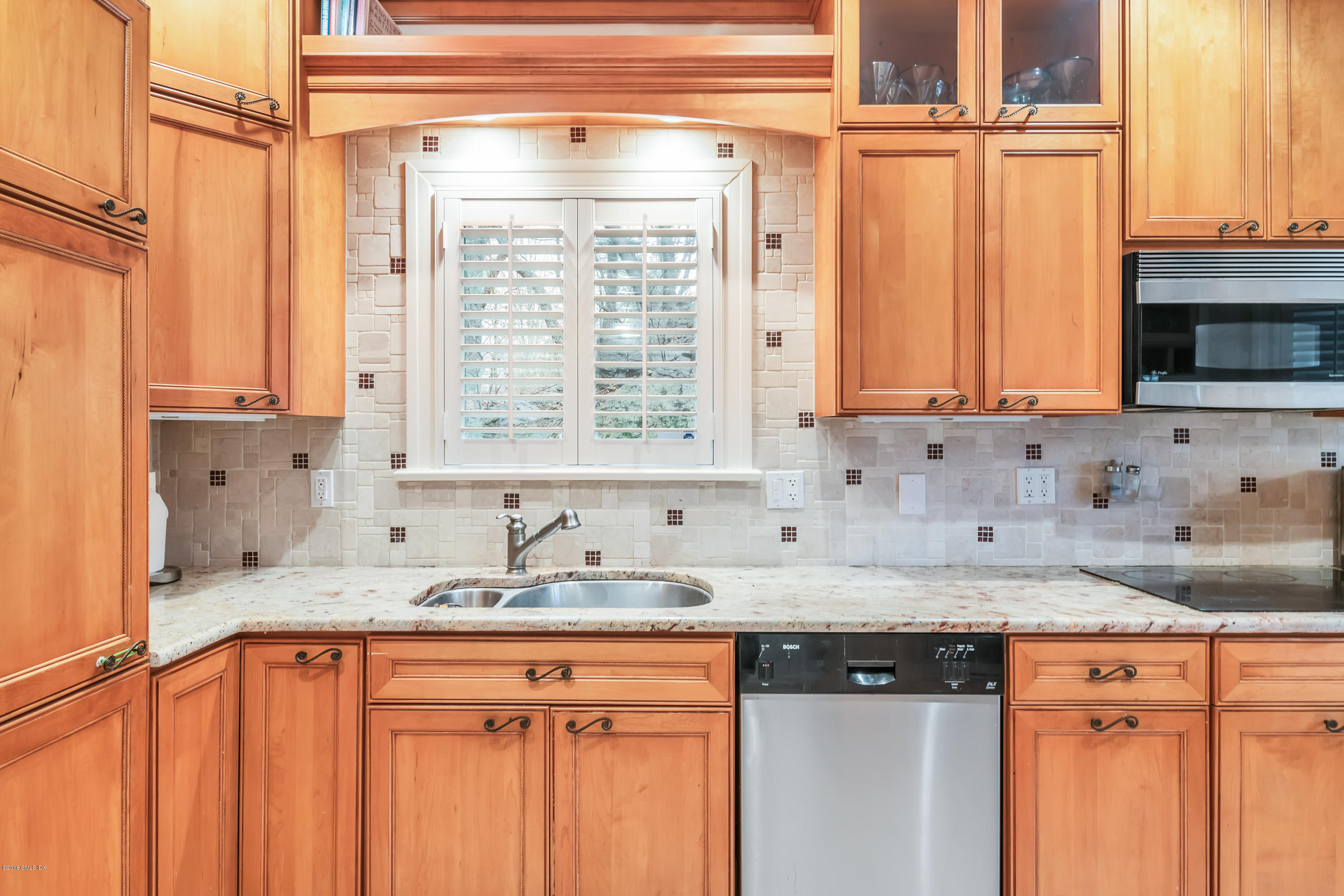 333 Palmer Hill Road, Unit 3D Riverside, CT 06878 - Photo 7 of 15 a kitchen with stainless steel appliances granite countertop a sink and a microwave