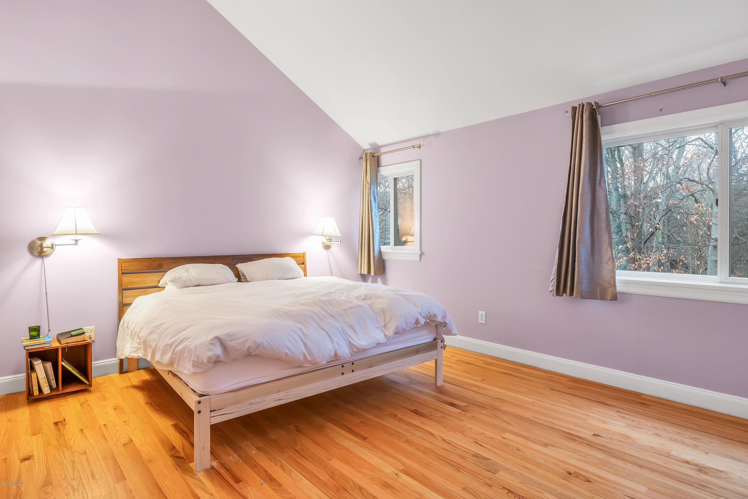 333 Palmer Hill Road, Unit 3D Riverside, CT 06878 - Photo 8 of 15 a bedroom with a bed and wooden floor