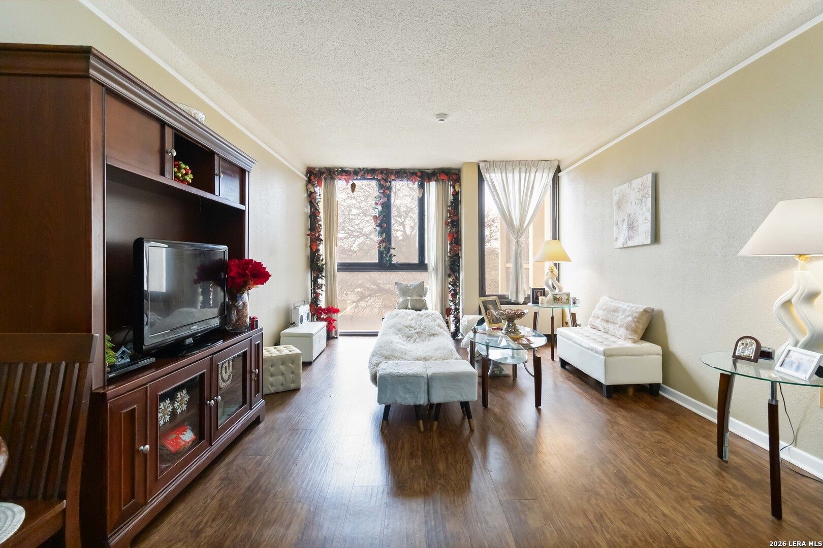 7701 Wurzbach Road, Unit 308 San Antonio, TX 78229 - Photo 2 of 17 a living room with furniture and a flat screen tv