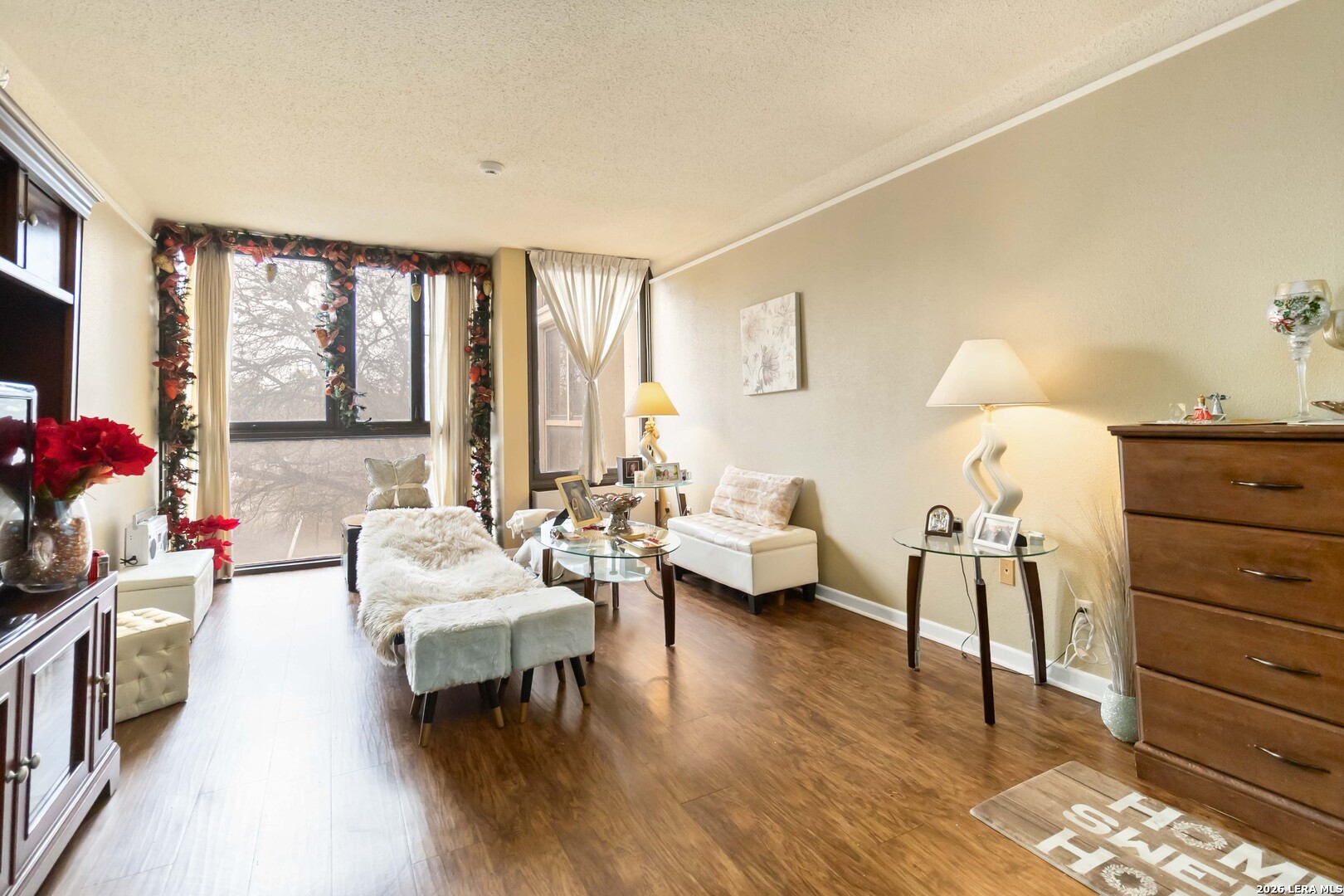 7701 Wurzbach Road, Unit 308 San Antonio, TX 78229 - Photo 3 of 17 a living room with furniture and wooden floor