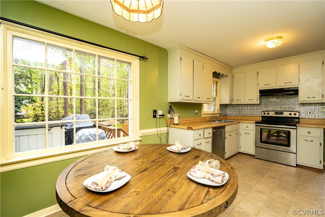 4624 Rabbit Foot Lane Chesterfield, VA 23236 - Photo 9 of 27 a kitchen with a granite countertop a white table and chairs in it