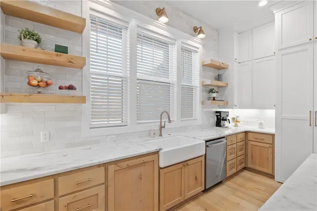 a kitchen with sink a stove and cabinets