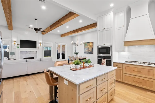 a kitchen with granite countertop a sink and a stove top oven with wooden floor