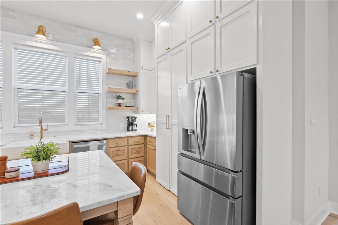 5001 Greenstone Way Bryan, TX 77802 - Photo 17 of 43 a kitchen with stainless steel appliances granite countertop a refrigerator and a sink