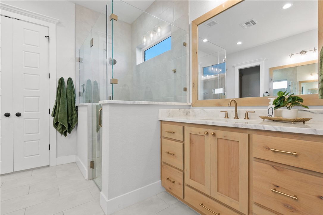 5001 Greenstone Way Bryan, TX 77802 - Photo 21 of 43 a bathroom with a granite countertop sink and a mirror