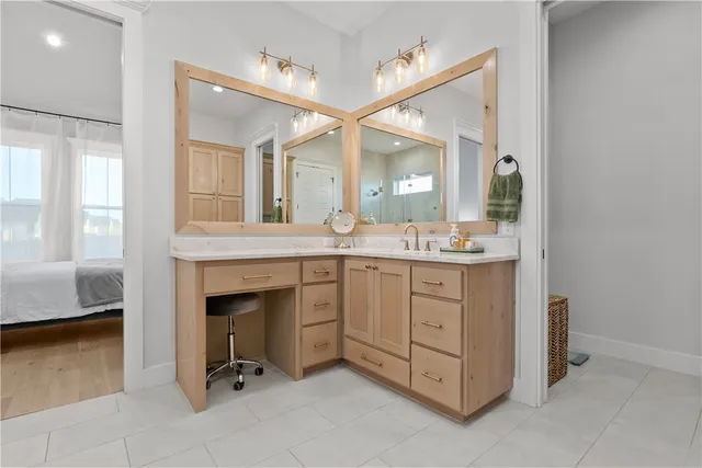a bathroom with a granite countertop sink and a mirror