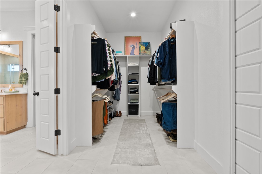 5001 Greenstone Way Bryan, TX 77802 - Photo 23 of 43 a view of walk in closet with clothes and shoes
