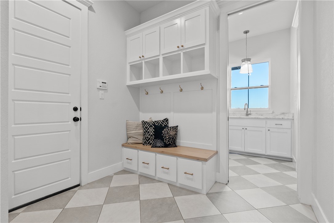 5001 Greenstone Way Bryan, TX 77802 - Photo 25 of 43 a kitchen with white cabinets and window
