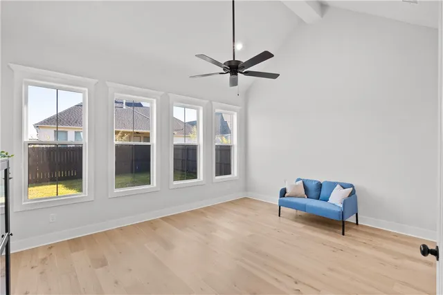 a kitchen with white cabinets and window