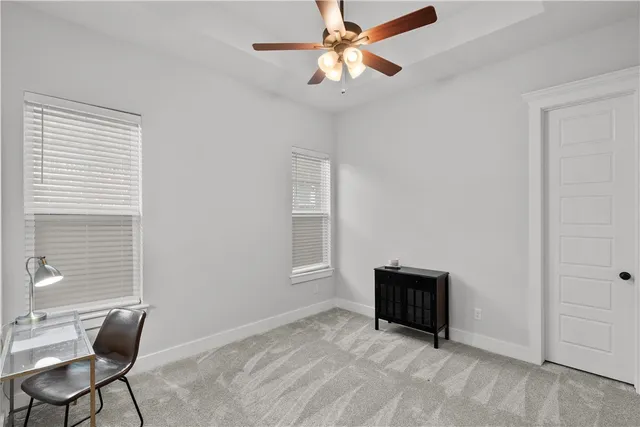 a view of room with cabinet and a ceiling fan