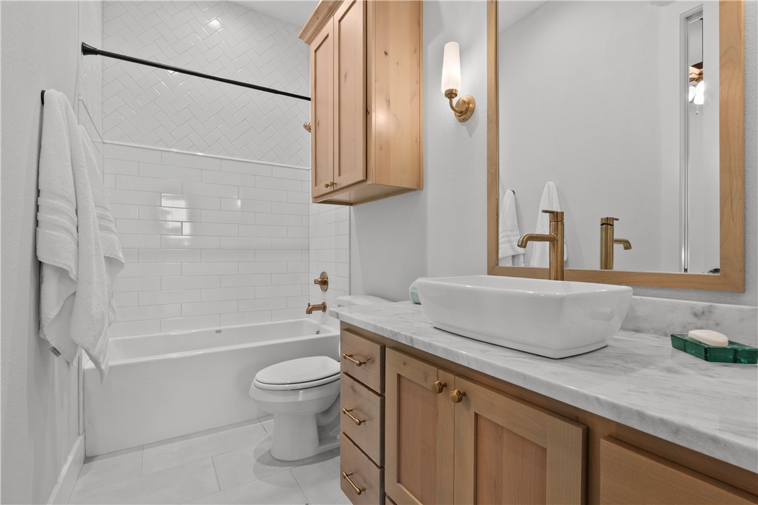 5001 Greenstone Way Bryan, TX 77802 - Photo 29 of 43 a bathroom with a granite countertop sink a toilet and shower